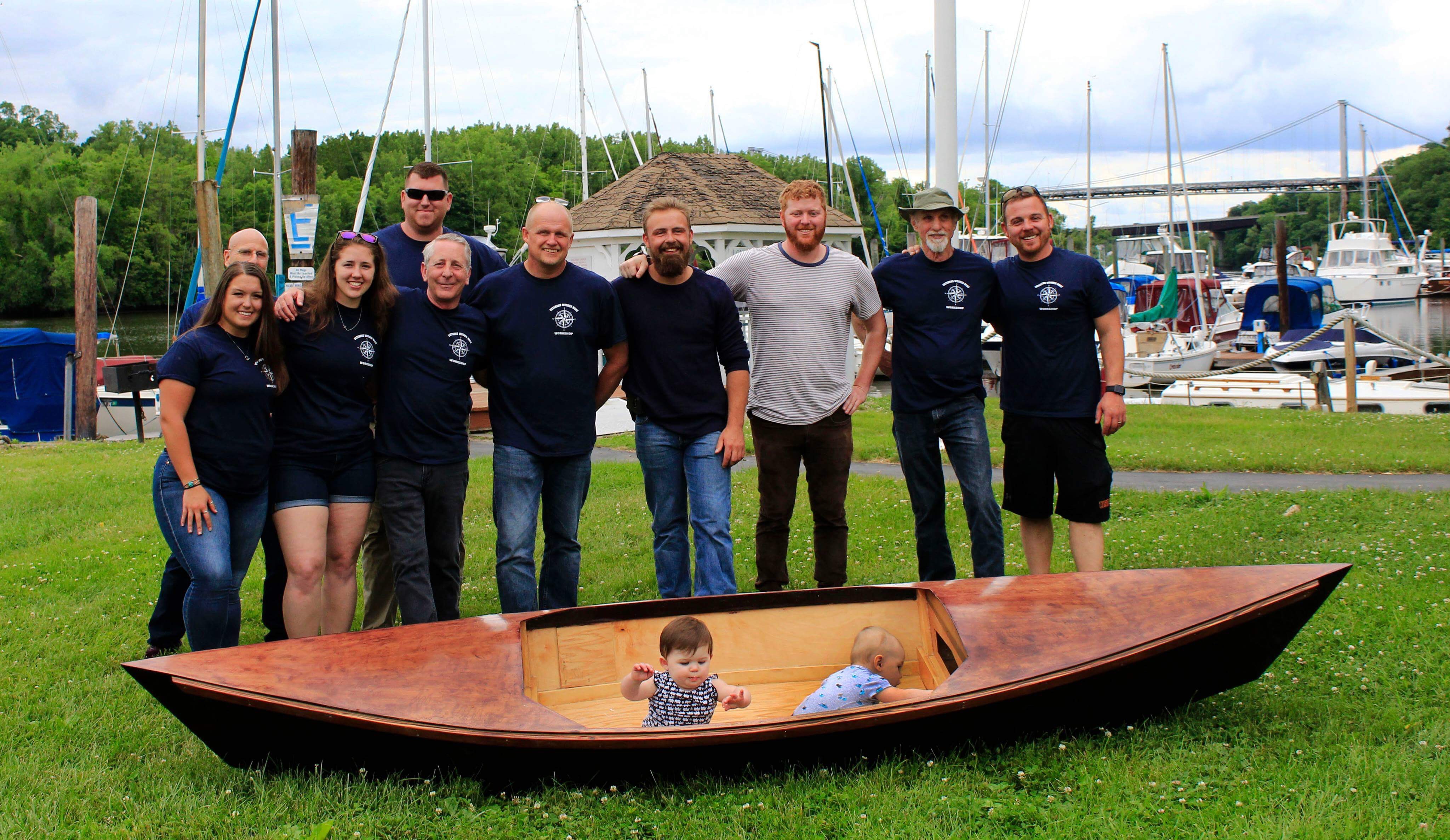 Our members standing next to a one of the kayaks they built this year.